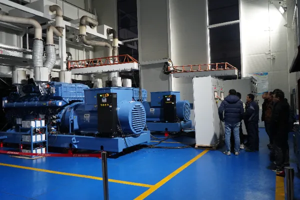 Team of engineers inspecting industrial diesel generator controls
