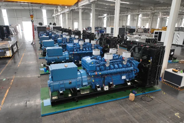 row of industrial diesel generators in yellow and blue soundproof canopies inside a large warehouse